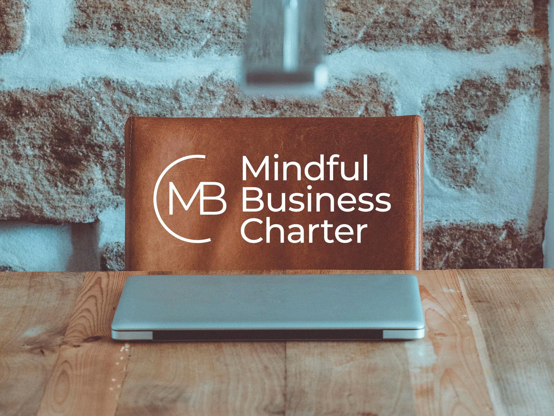 laptop with mindful business charter logo
